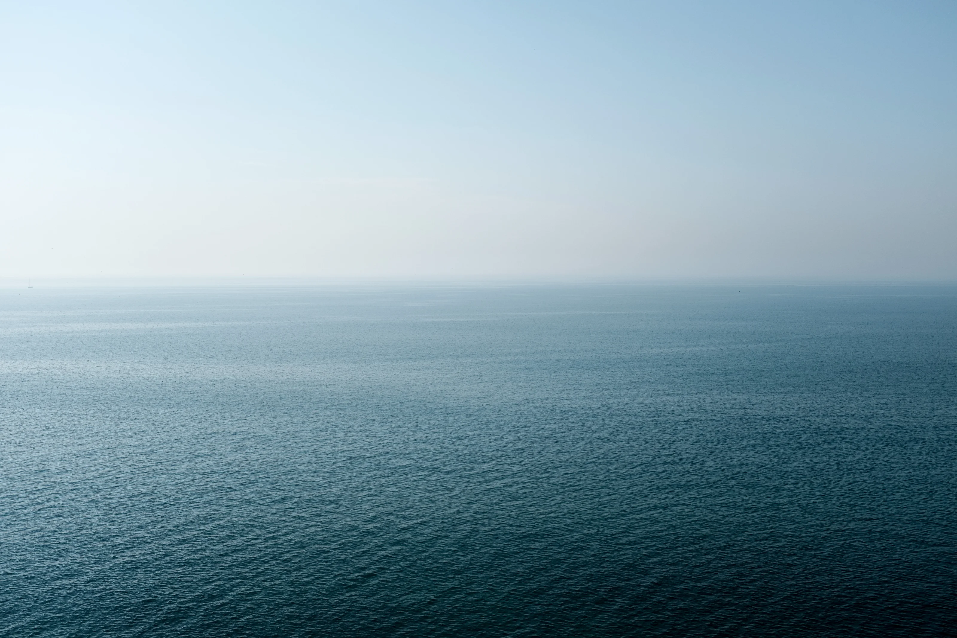 Calm ocean view under a clear sky.